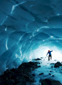 exploring an ice cave made by glacier